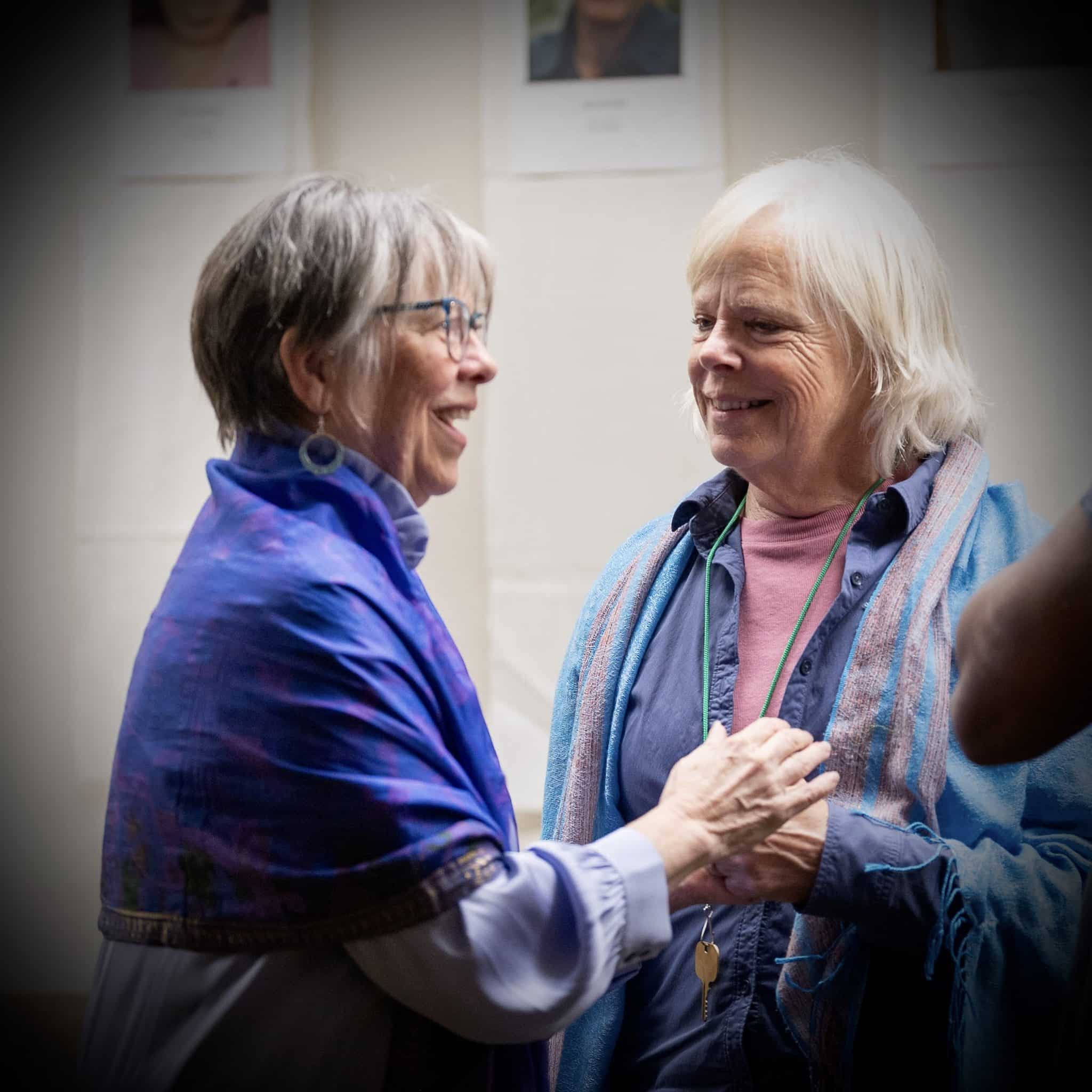Meditation teaching joyfully hugging her student
